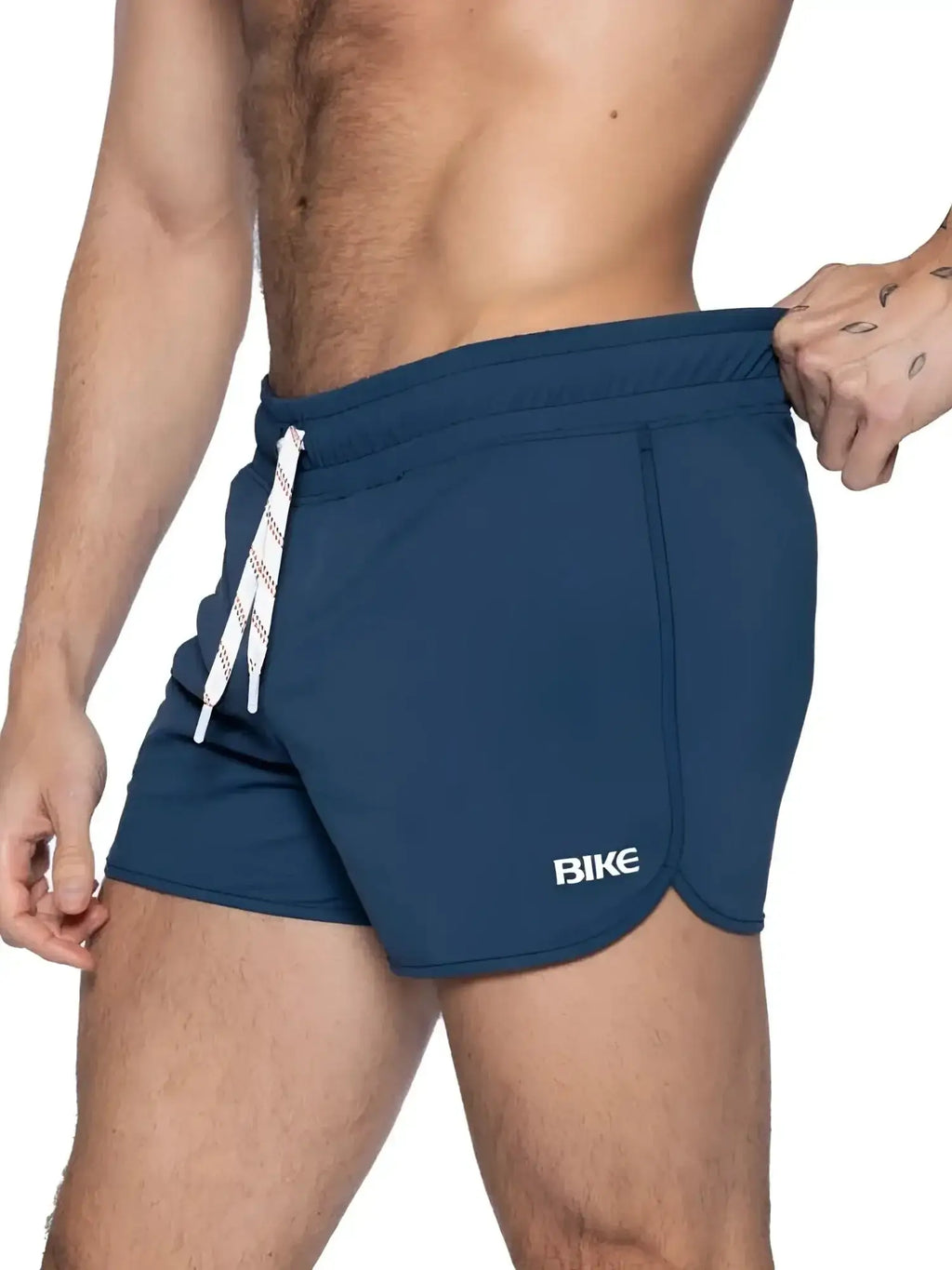 Side view of a man wearing navy BIKE Athletic BAM200 track shorts with a drawstring waist.