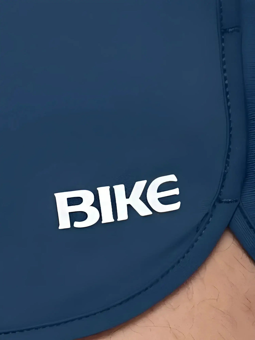 Close-up detail view of the navy BIKE Athletic BAM200 track short featuring the brand logo.