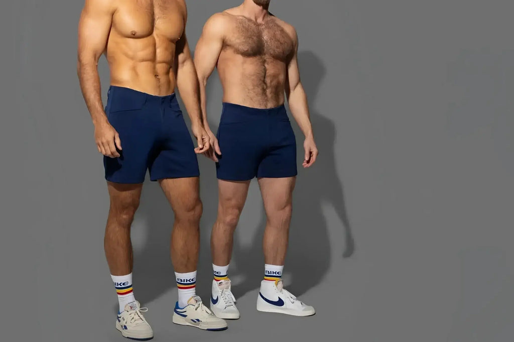 Two men modeling navy BIKE Athletic BAM207 Coaches 5-inch shorts in a lifestyle studio shot.