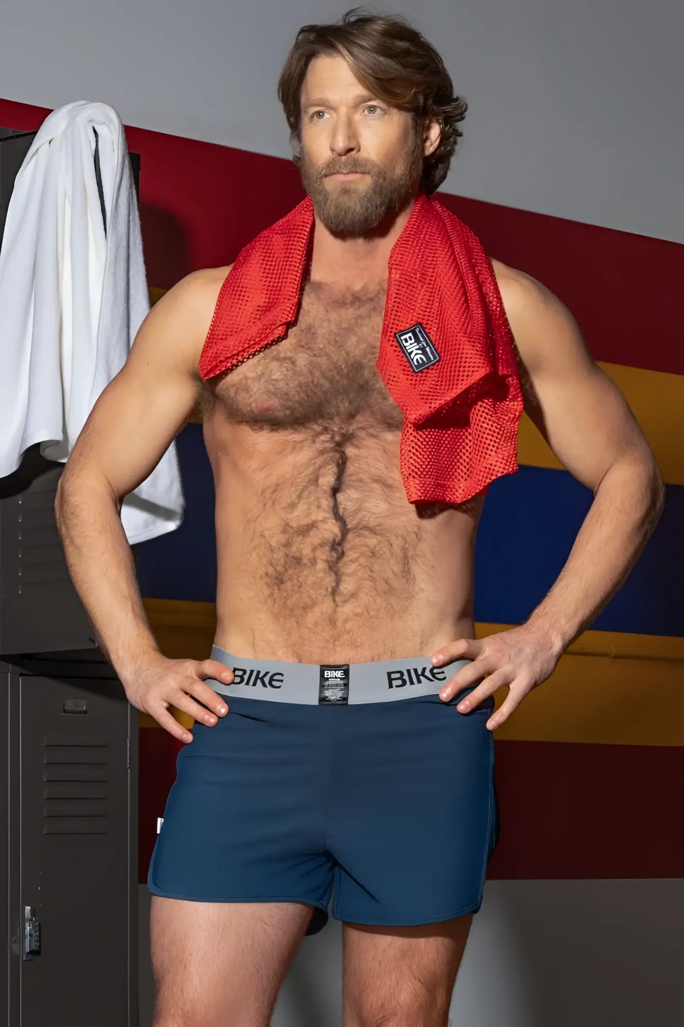 BIKE Athletic BAM216 Performance Jock Short in navy. Lifestyle shot of a man in a locker room.