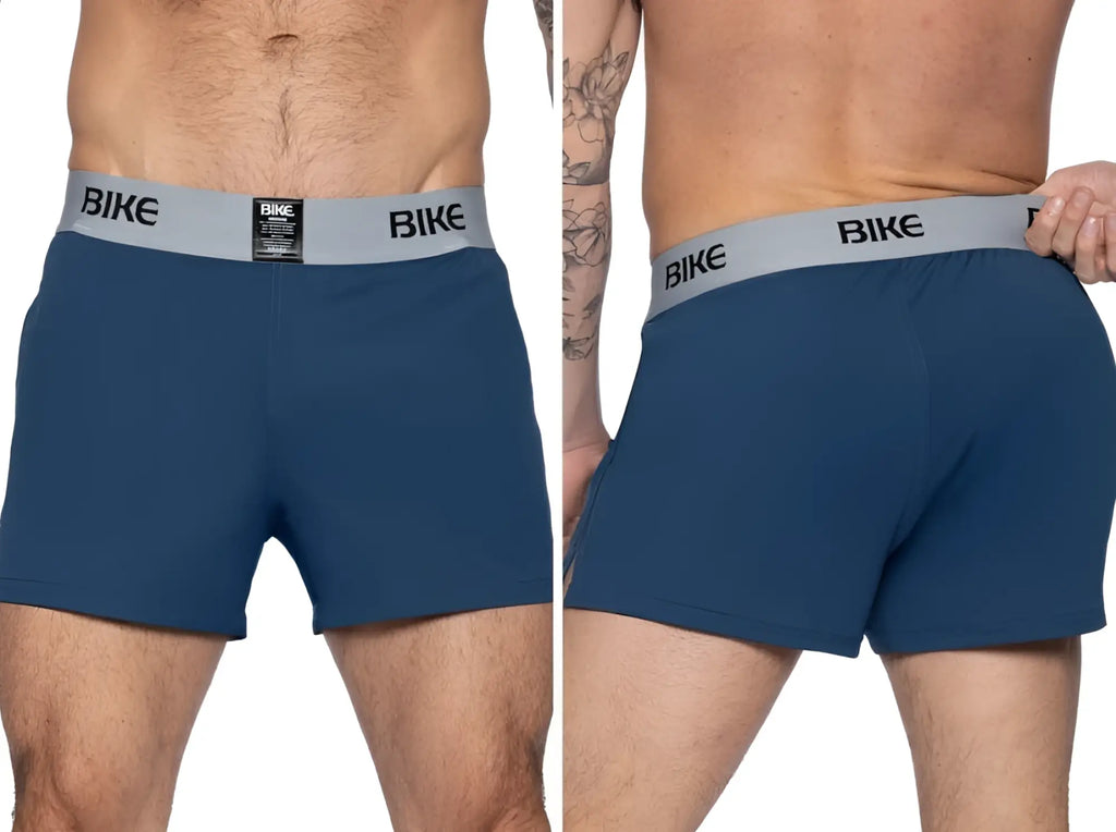 Navy blue athletic shorts with a grey branded "BIKE" elastic waistband. Smooth, performance-fabric trunk style.