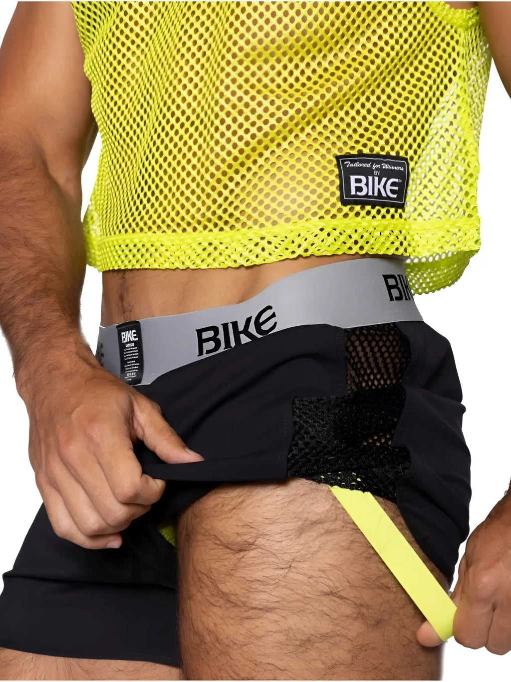 BIKE Athletic BAM225 Peek-a-boo Jock Short in black. Side view showing the cut-out detail on a model.