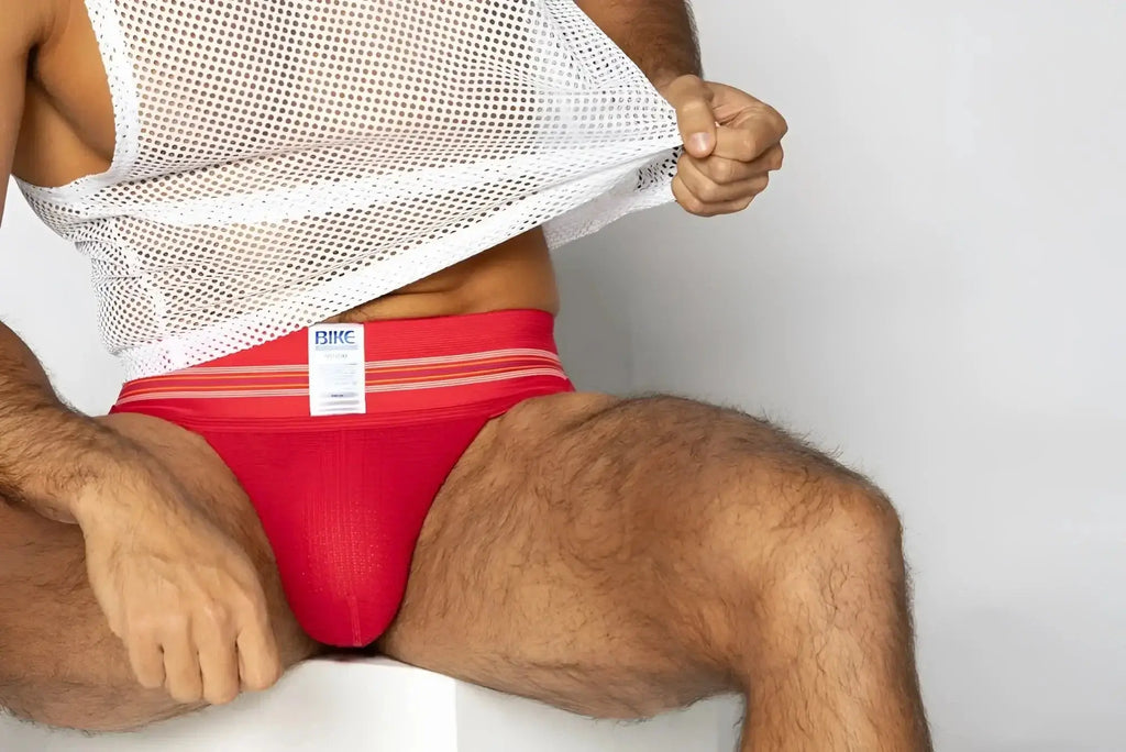 BIKE Athletic BAS306 Original Number 10 jockstrap in red. Front lifestyle view of the model wearing the underwear.