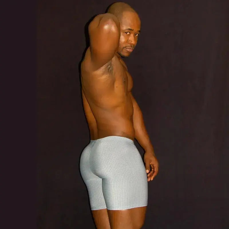 Men's compression cycling shorts in a light gray checkered pattern shown on a model by Arroyman.