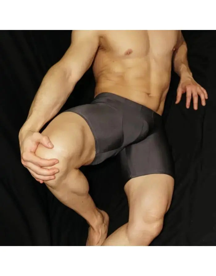 Steel grey compression shorts by Arroyman featuring a snug fit and smooth fabric shown on a model in a seated pose.