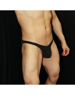 Black eco-leather bikini underwear by Arroyman featuring a minimal design and snug fit shown on a model.