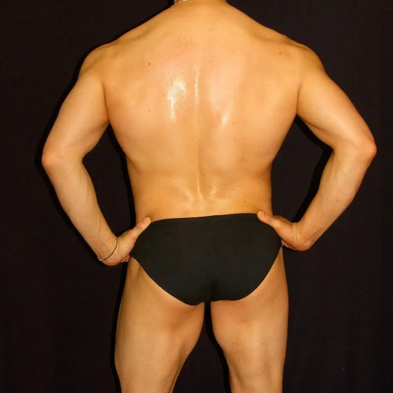 Men's black bikini spandex underwear by Arroyman featuring a snug fit and smooth fabric shown from the back on a model.