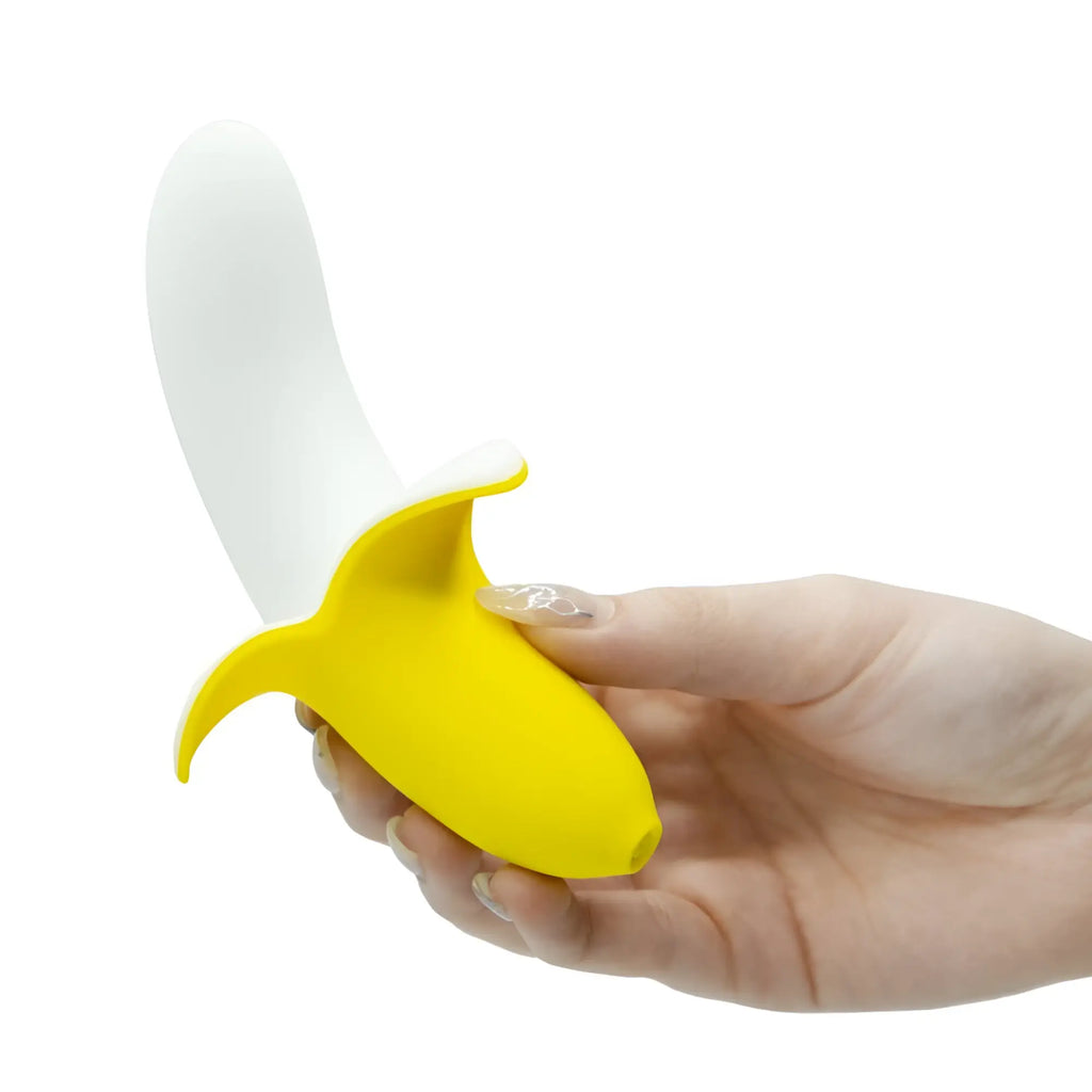 Yellow and white silicone banana-shaped vibrator held in hand bms banana bliss 13cm slimline massager