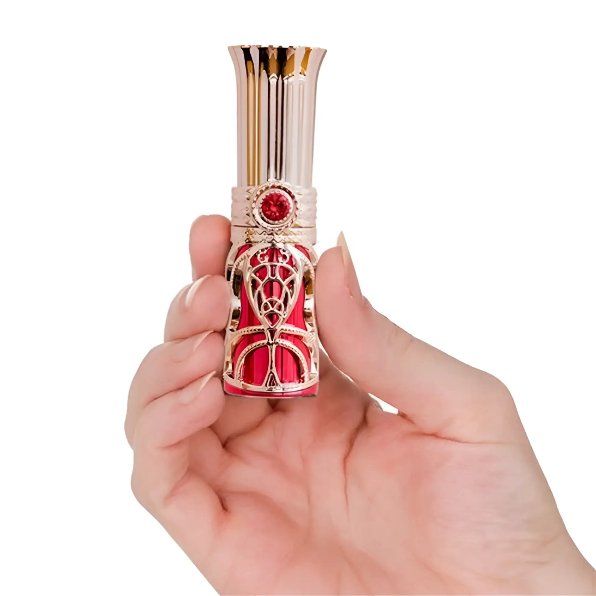 A delicate rose gold bms ruby kiss 4 in 1 lipstick vibrator with intricate filigree and a red gemstone accent