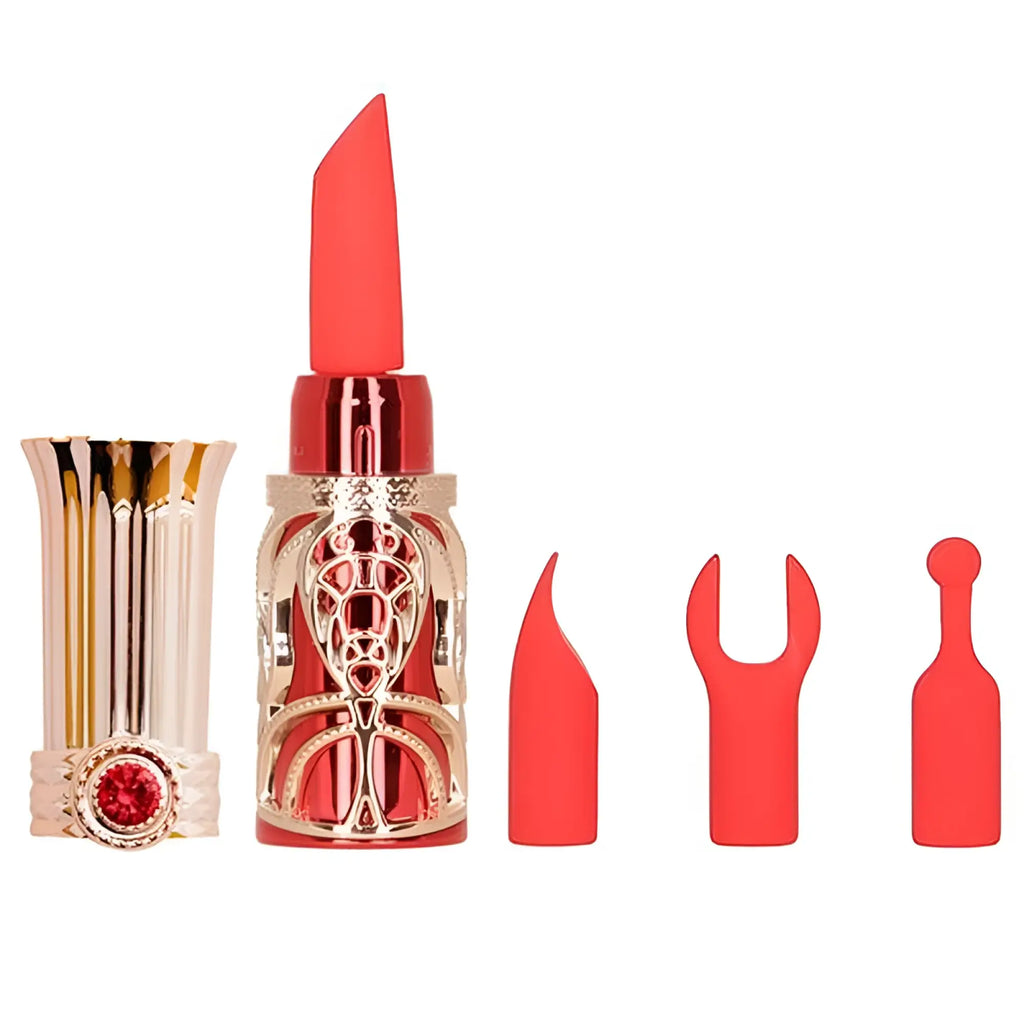 A vibrant coral-red bms ruby kiss 4 in 1 lipstick vibrator with ornate gold-toned metallic case and red gemstone accent