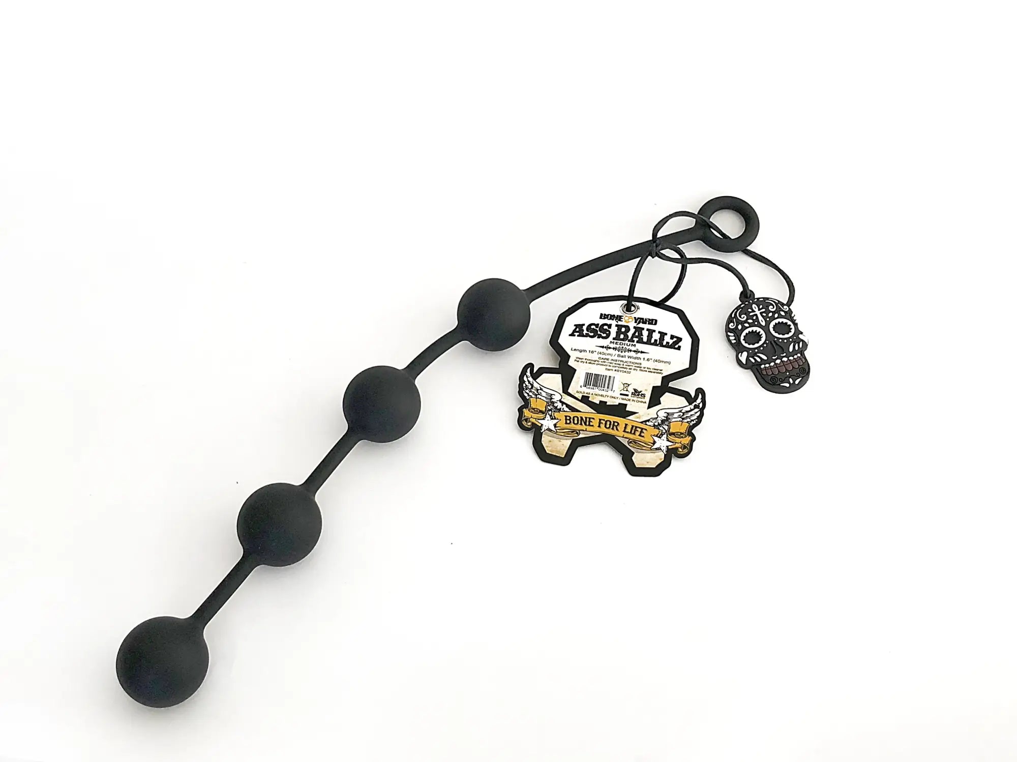 Black silicone boneyard ass ballz medium anal toy with five spherical beads and skull charm visible from the back side