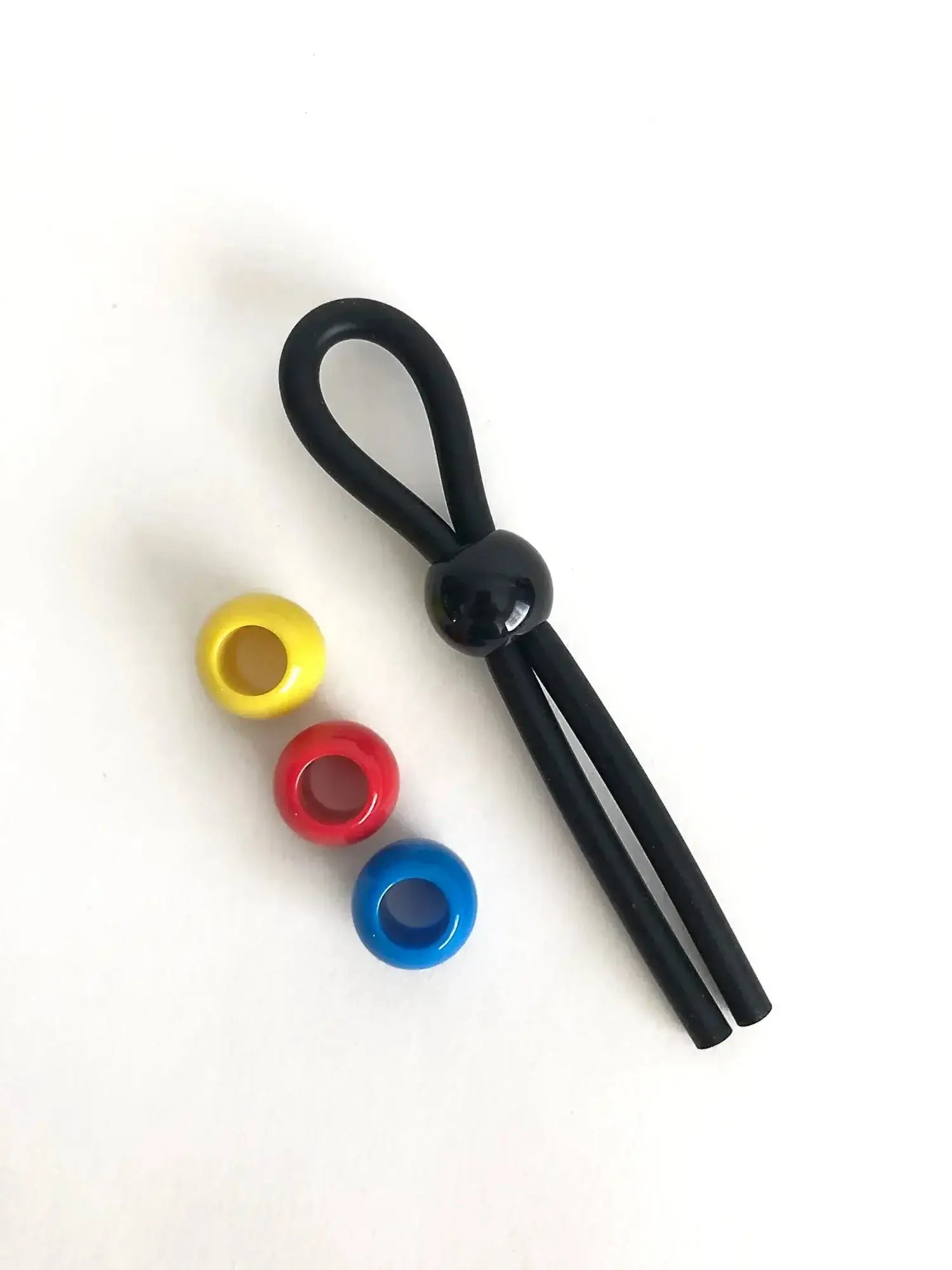 Black silicone boneyard cock leash single with central spherical bead and three colorful translucent yellow red blue rings