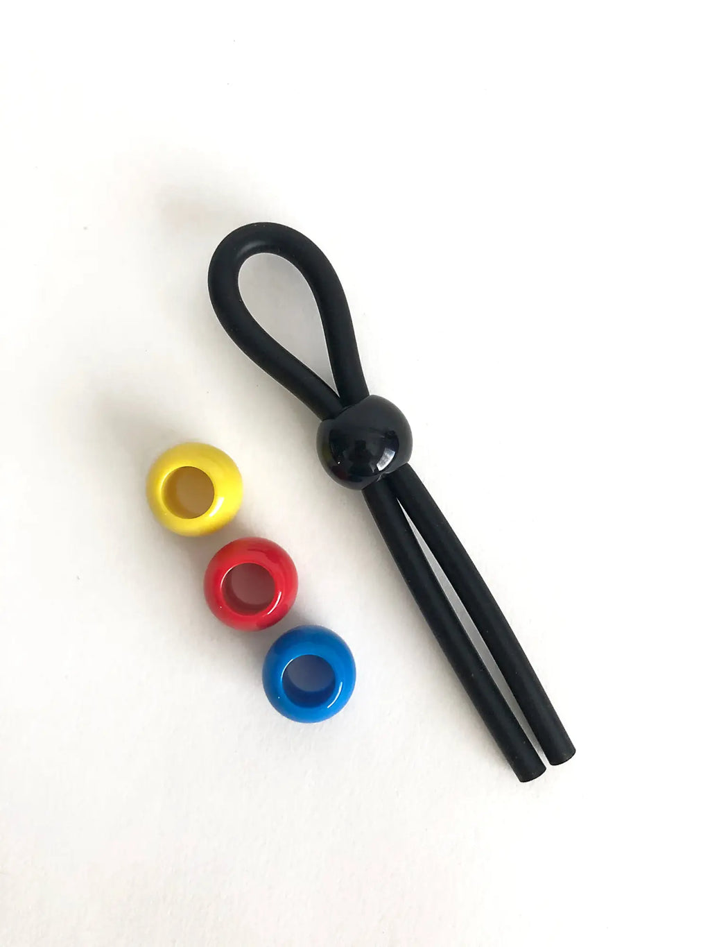 Black silicone boneyard cock leash single with central spherical bead and three colorful translucent yellow red blue rings