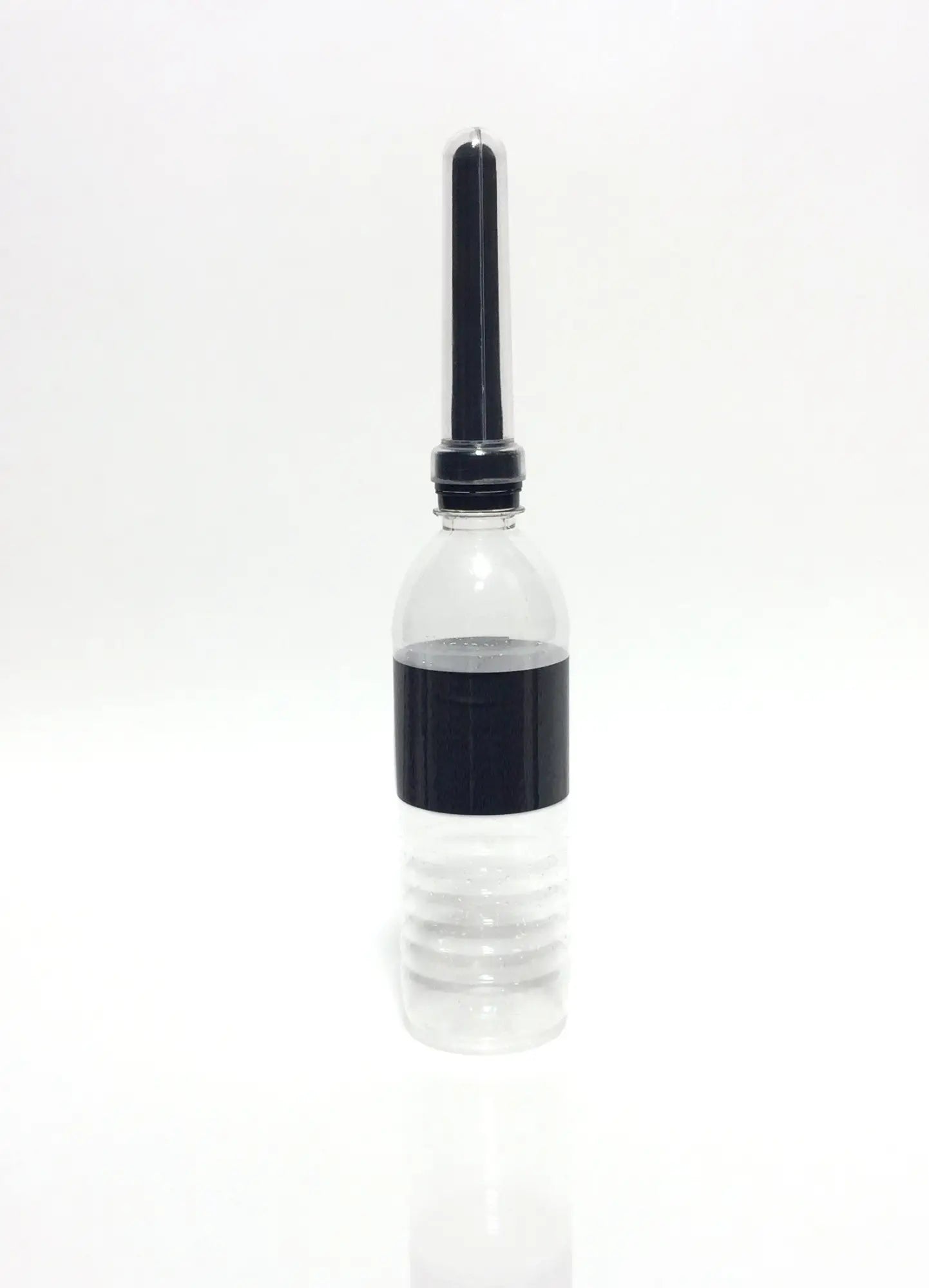 Clear plastic bottle with black cap and band holding clear liquid from boneyard the skwert 5 pc douche kit clamshell