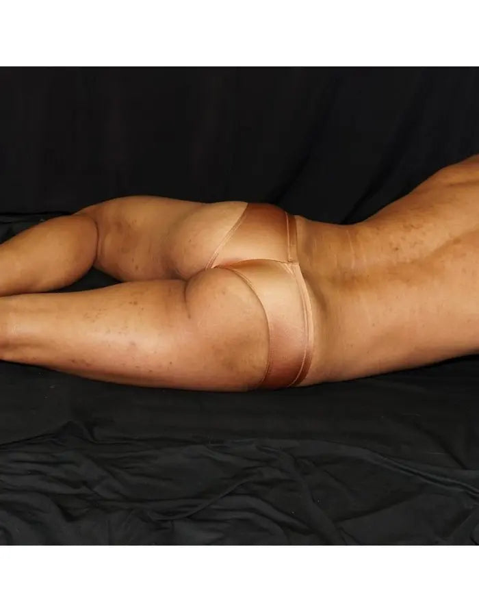 Copper boxer underwear by Arroyman featuring a smooth finish and snug fit shown on a model against a dark background.