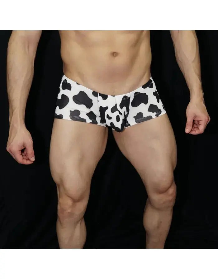 Men's cow print boxer underwear in white and black featuring a snug fit shown on a model by Arroyman.