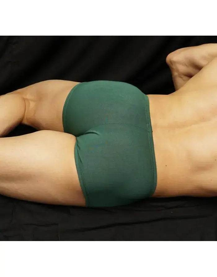 Green viscose boxer underwear by Arroyman featuring a snug fit and smooth fabric shown on a model from the side.