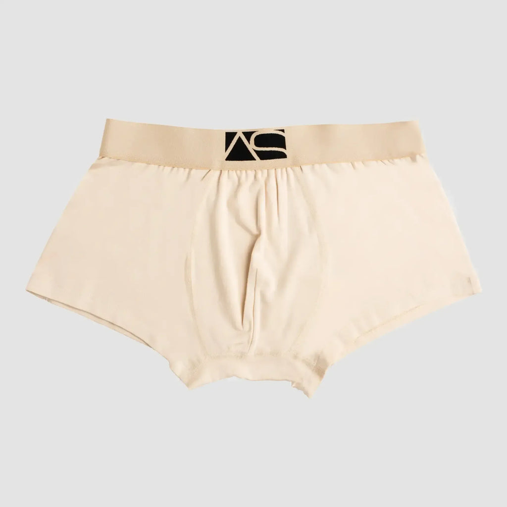 Beige menâs boyshorts briefs with a black logo waistband designed for comfortable everyday wear