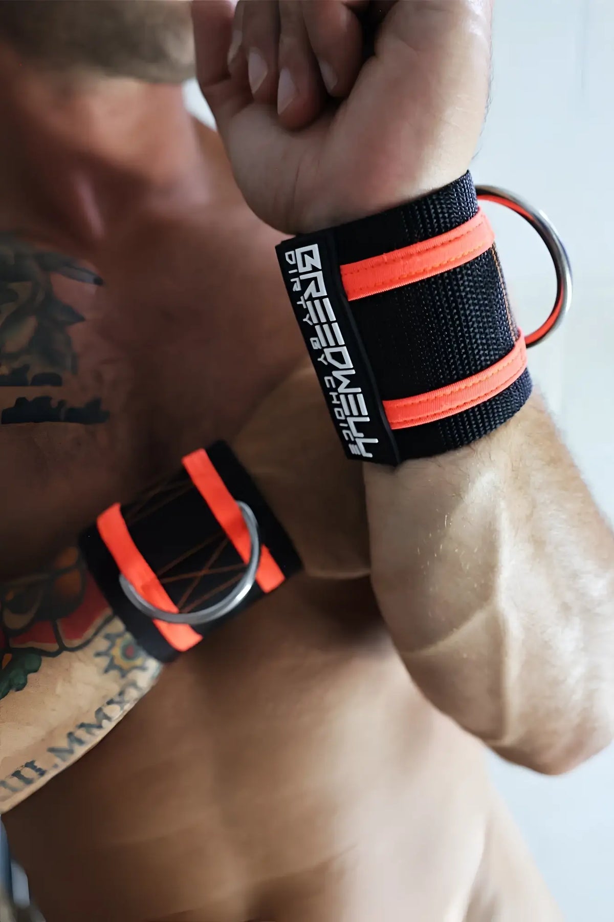 Breedcore ruff cuffs black and neon orange wrist wraps with metal ring branded muscle for weightlifting support