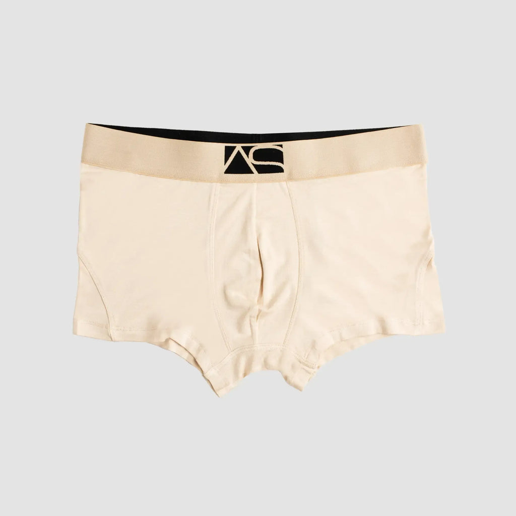 Beige brief trunks boxer briefs with black waistband featuring stylized as logo for comfortable everyday wear