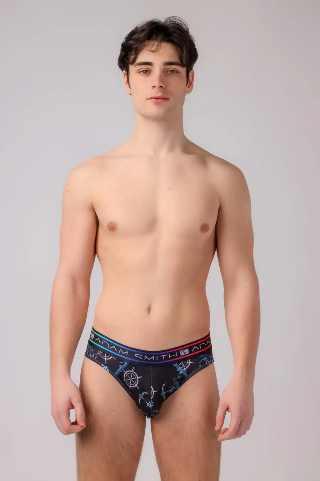 Black menâs briefs with a nautical anchor and ship wheel pattern in blue white and red accents