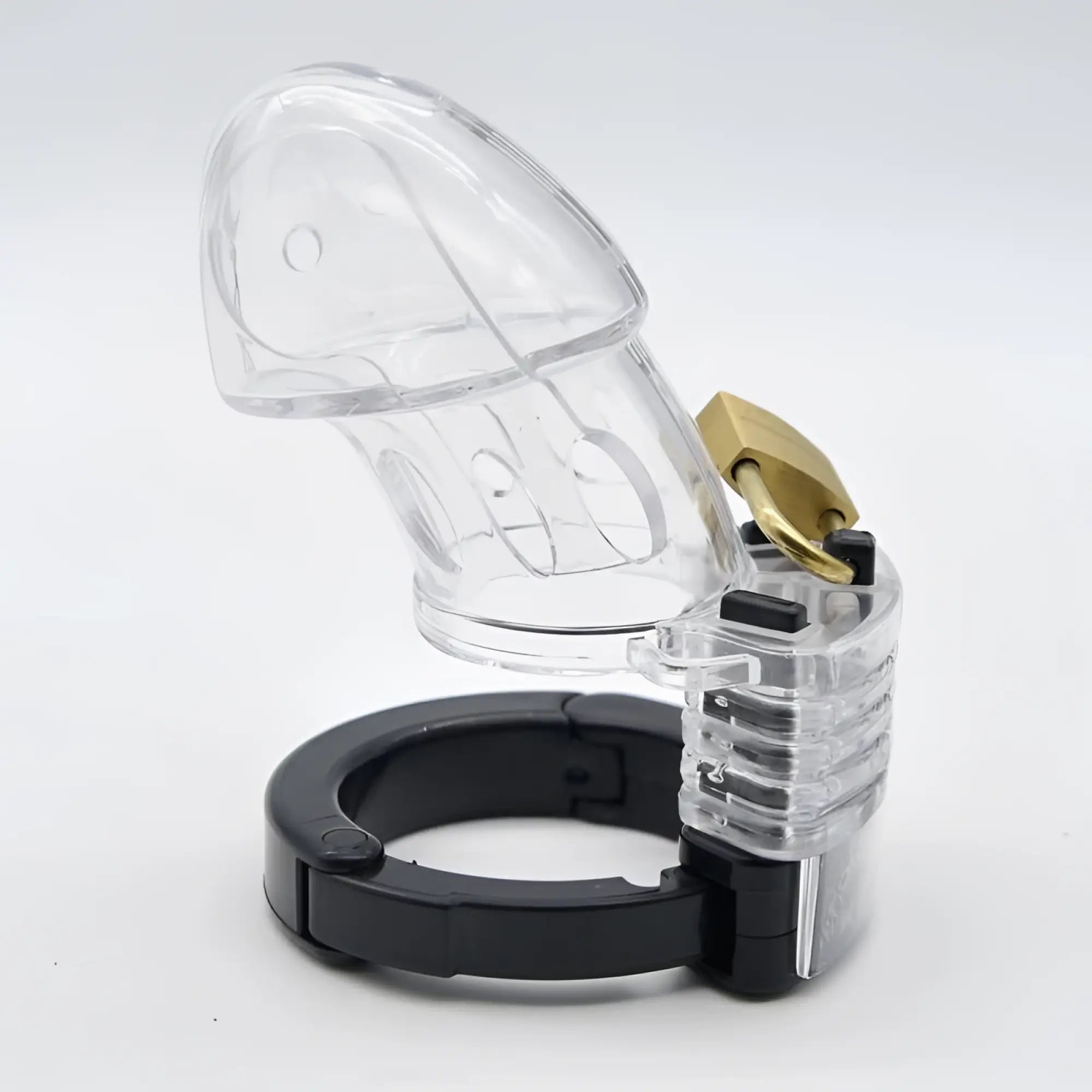 Brutus Brutus Alpha chastity cage clear made of clear plastic with a gold-colored lock and black base ring