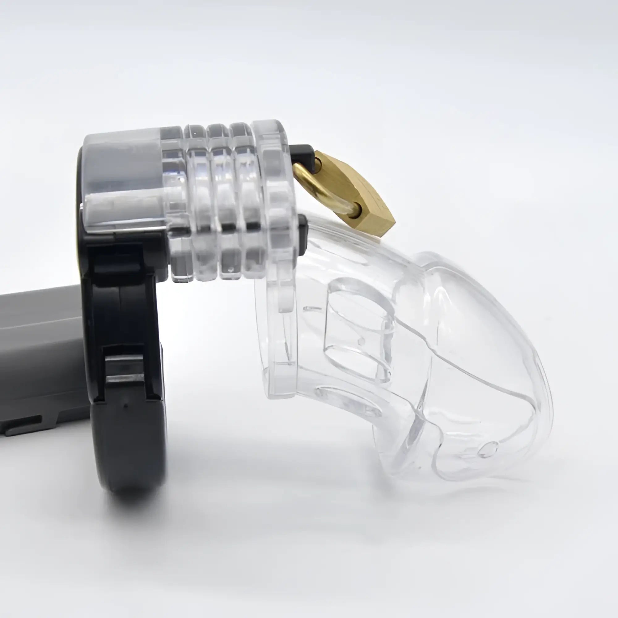 Brutus alpha chastity cage clear transparent plastic with gold lock and black adjustable strap for secure wear