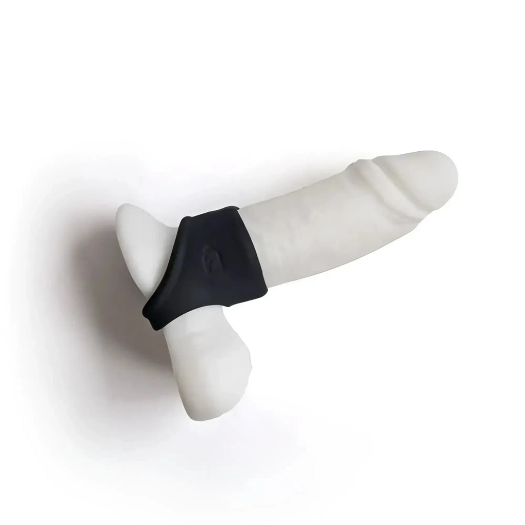 White silicone dildo with black grip band from brutus brutus shaft hugger hypersoft cocksling shown from the back side