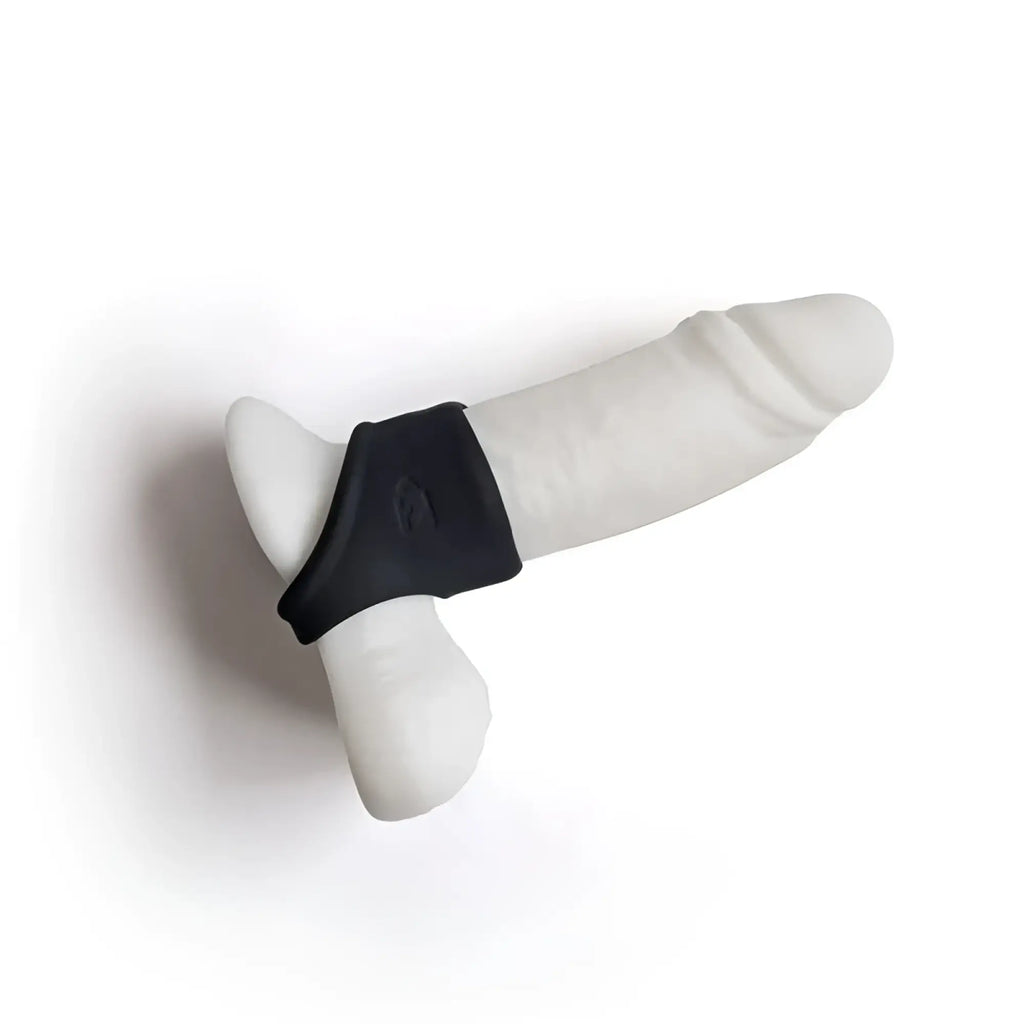 White silicone dildo with black grip band from brutus brutus shaft hugger hypersoft cocksling shown from the back side