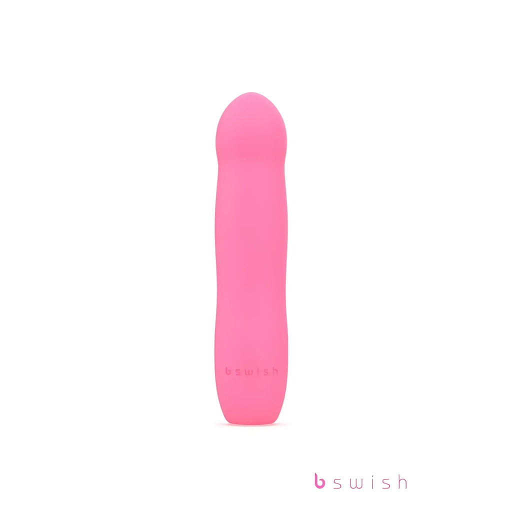 Pink silicone pleasure toy b swish bdesired infinite deluxe in flamingo pink with smooth rounded design and embossed logo