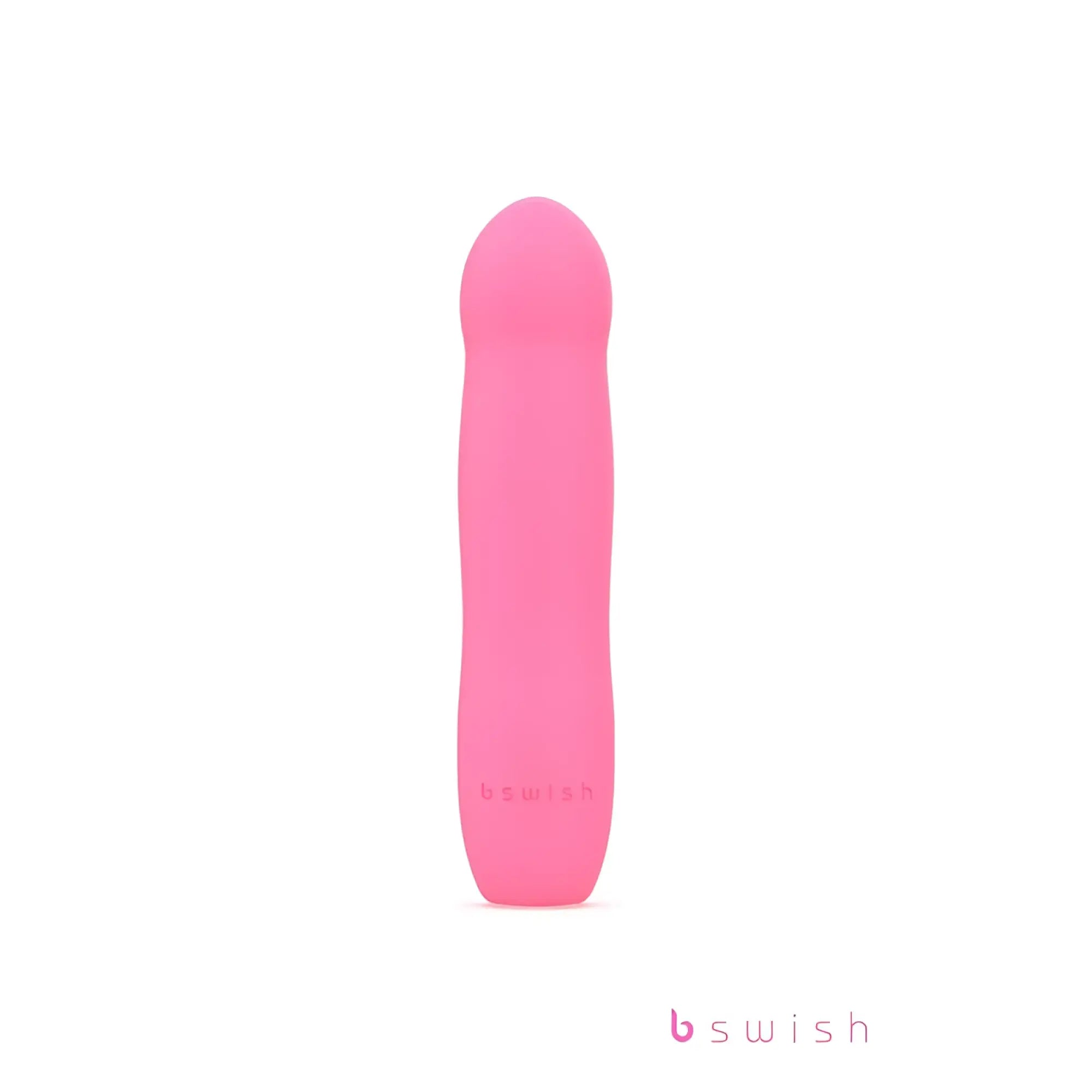 Pink silicone pleasure toy b swish bdesired infinite deluxe in flamingo pink with smooth rounded design and embossed logo
