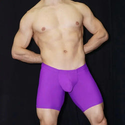 Purple athletic shorts by Arroyman featuring a snug fit and supportive design shown on a model with a bare torso.