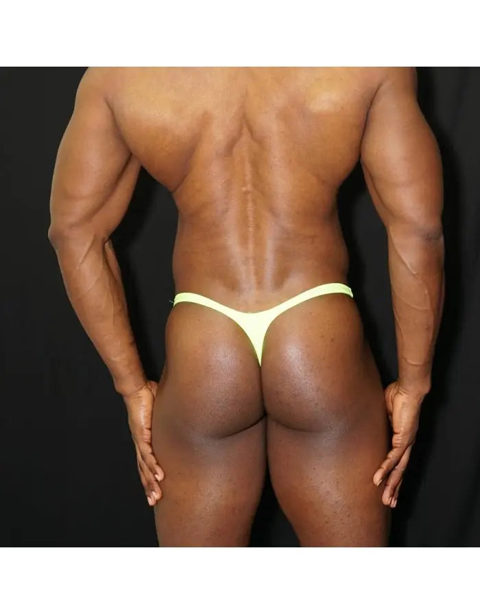 Men's green fluor thong underwear by Arroyman featuring a minimal design and elastic waistband shown on a model from the back.