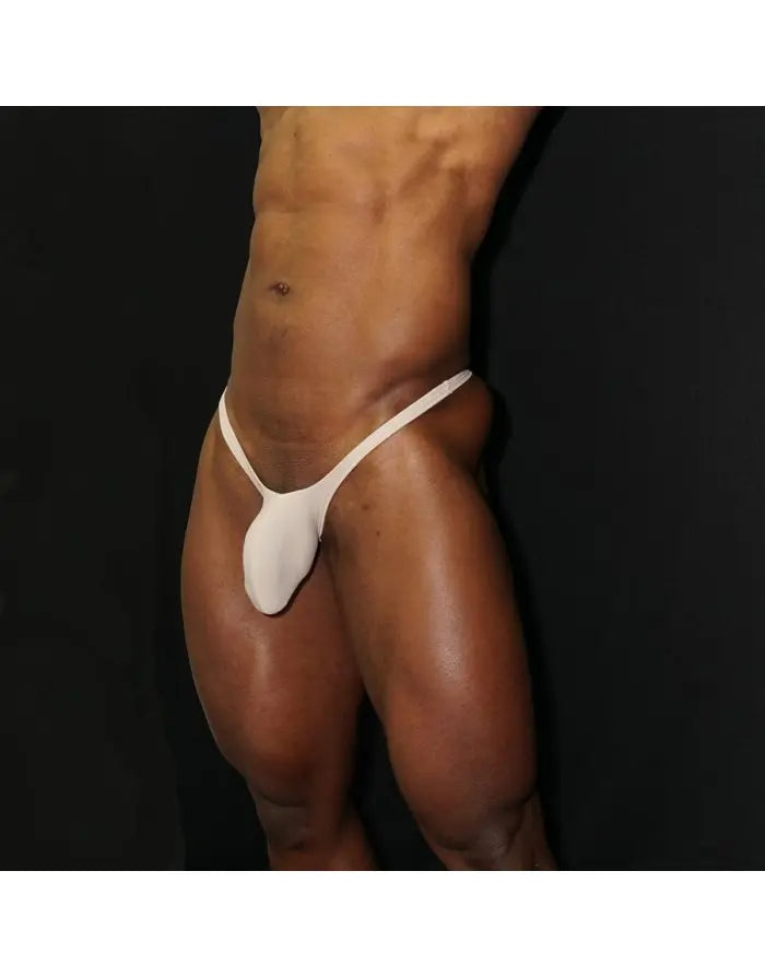 Beige thong underwear by Arroyman featuring a bulge-enhancing pouch and minimal coverage design.