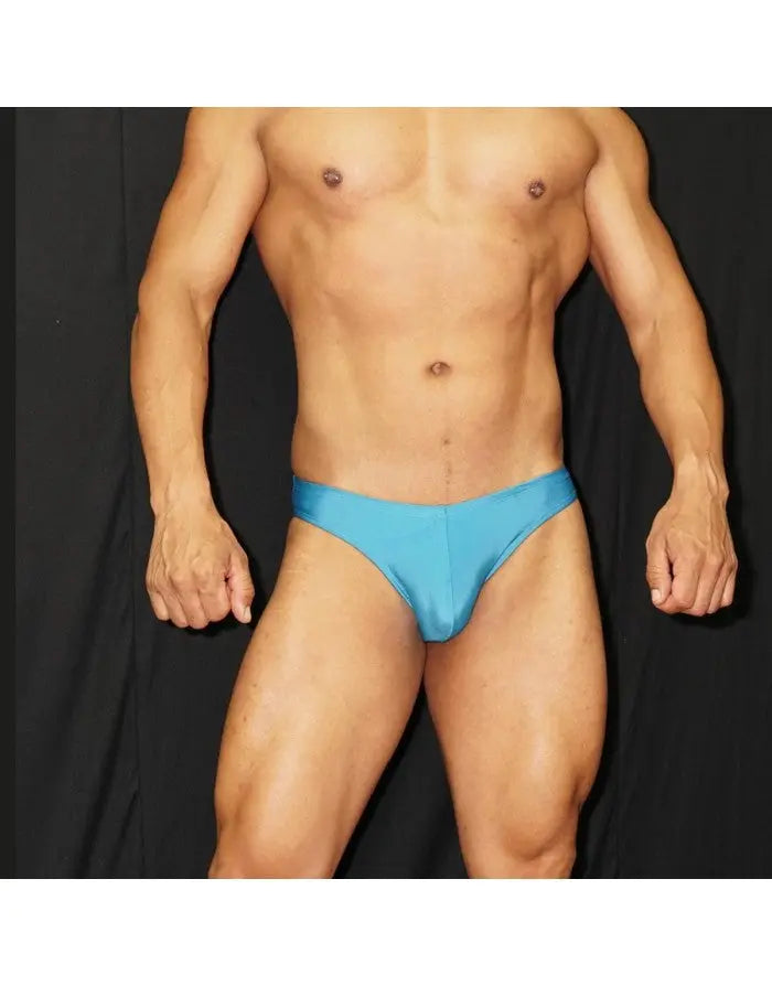 Men's bikini swimwear in bright blue made of smooth fabric featuring a low-rise cut shown on a model by Arroyman.