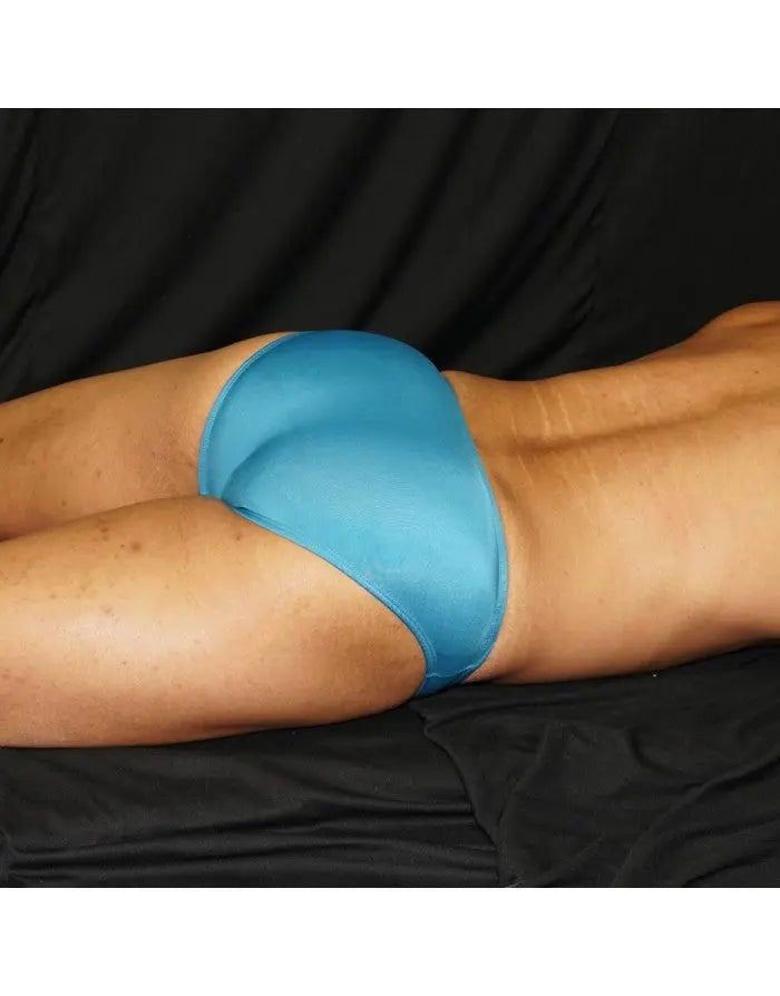 Blue bikini swimwear by Arroyman featuring a smooth fitted design shown on a model against a dark background.