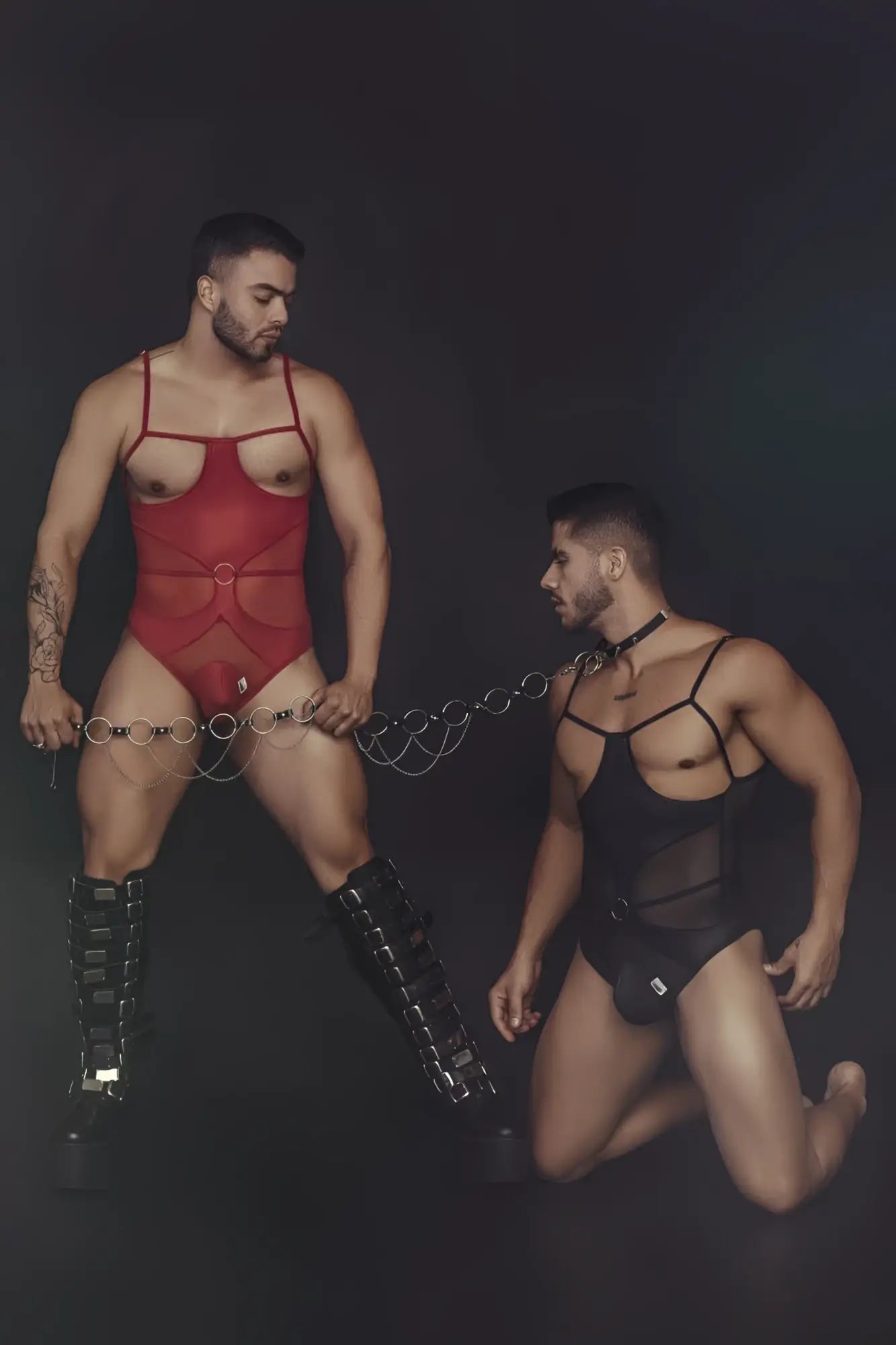 Red mesh candyMan 99670 harness bodysuit with thin straps and central circular buckle in red color