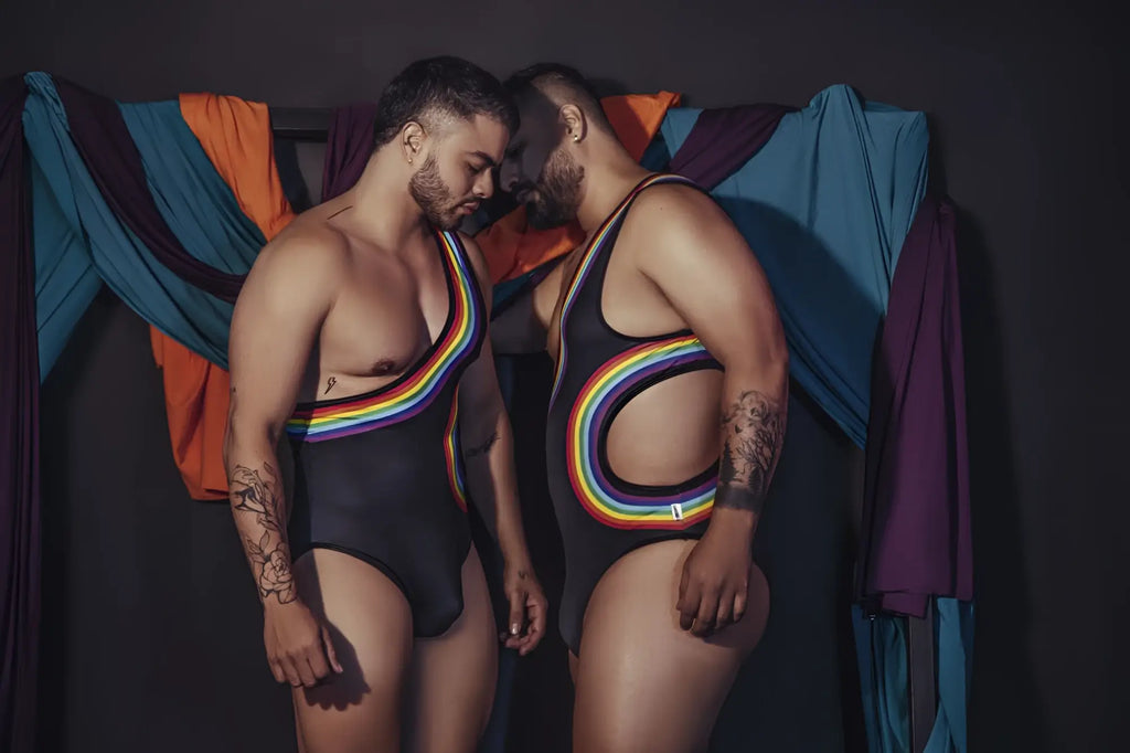 Black one-piece CandyMan 99702X bodysuit with rainbow-colored stripes and cutouts designed for bold swimwear looks