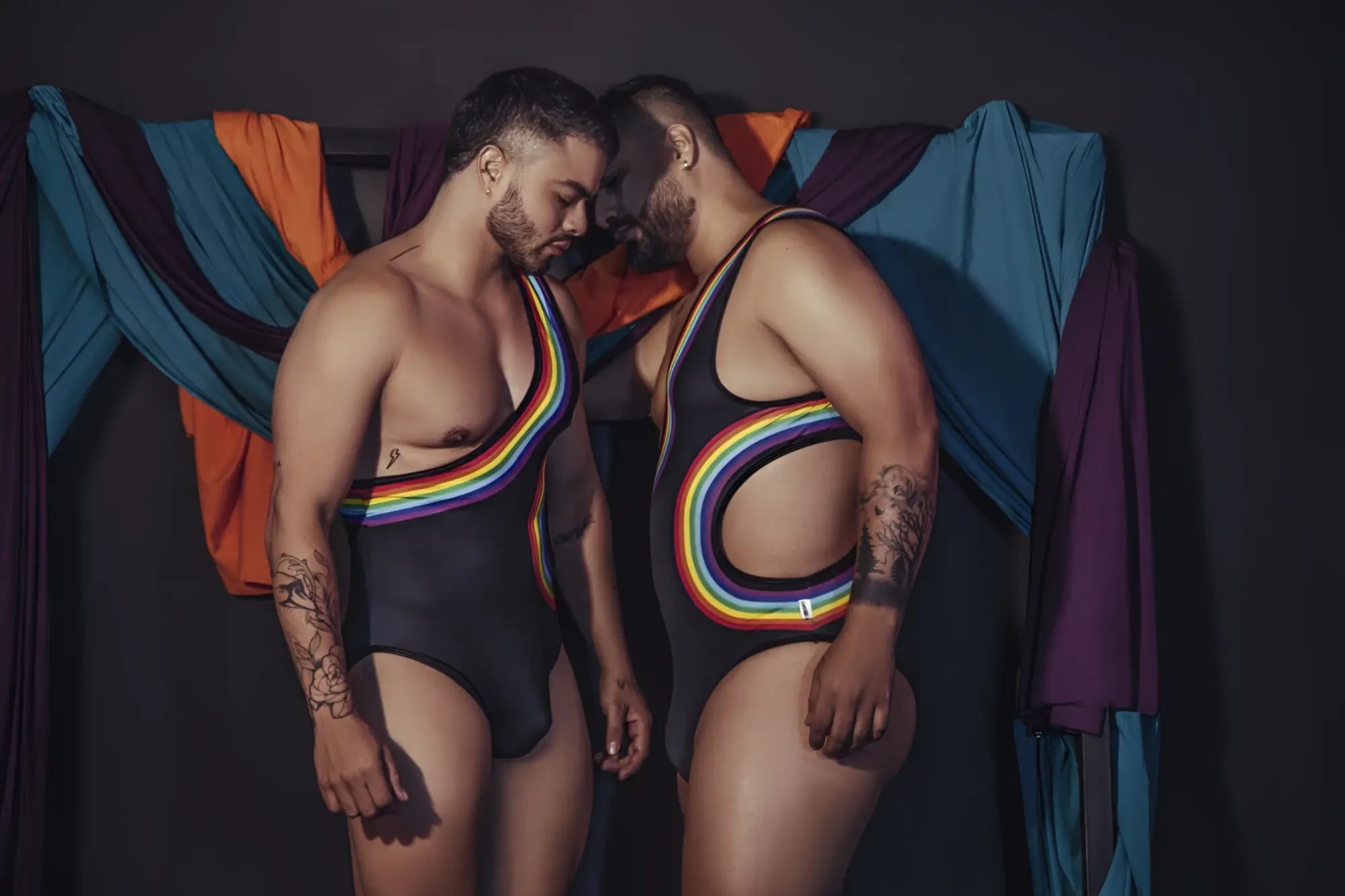 Black one-piece CandyMan 99702X bodysuit with rainbow-colored stripes and cutouts designed for bold swimwear looks