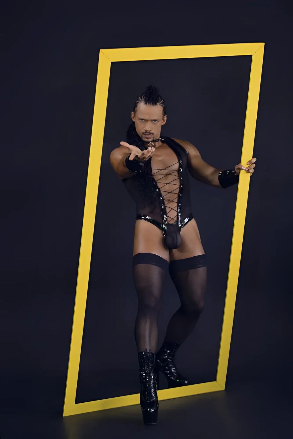 Black candyMan 99774 gladiator bodysuit with lace-up front sheer mesh panels paired with high-heeled boots