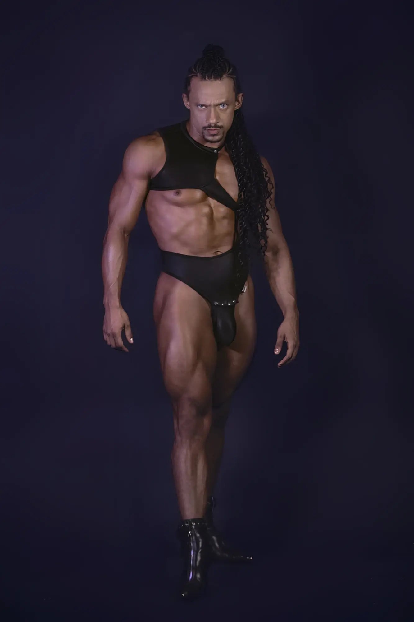 Black leather bodysuit candyMan 99783 with one shoulder cut-out design and matching black boots