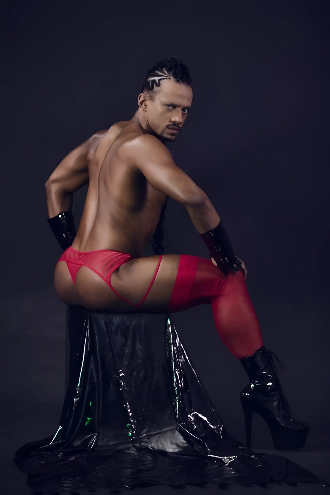 Red latex candyMan 99792 mesh garter thongs with matching arm cuffs and black high-heeled boots front view