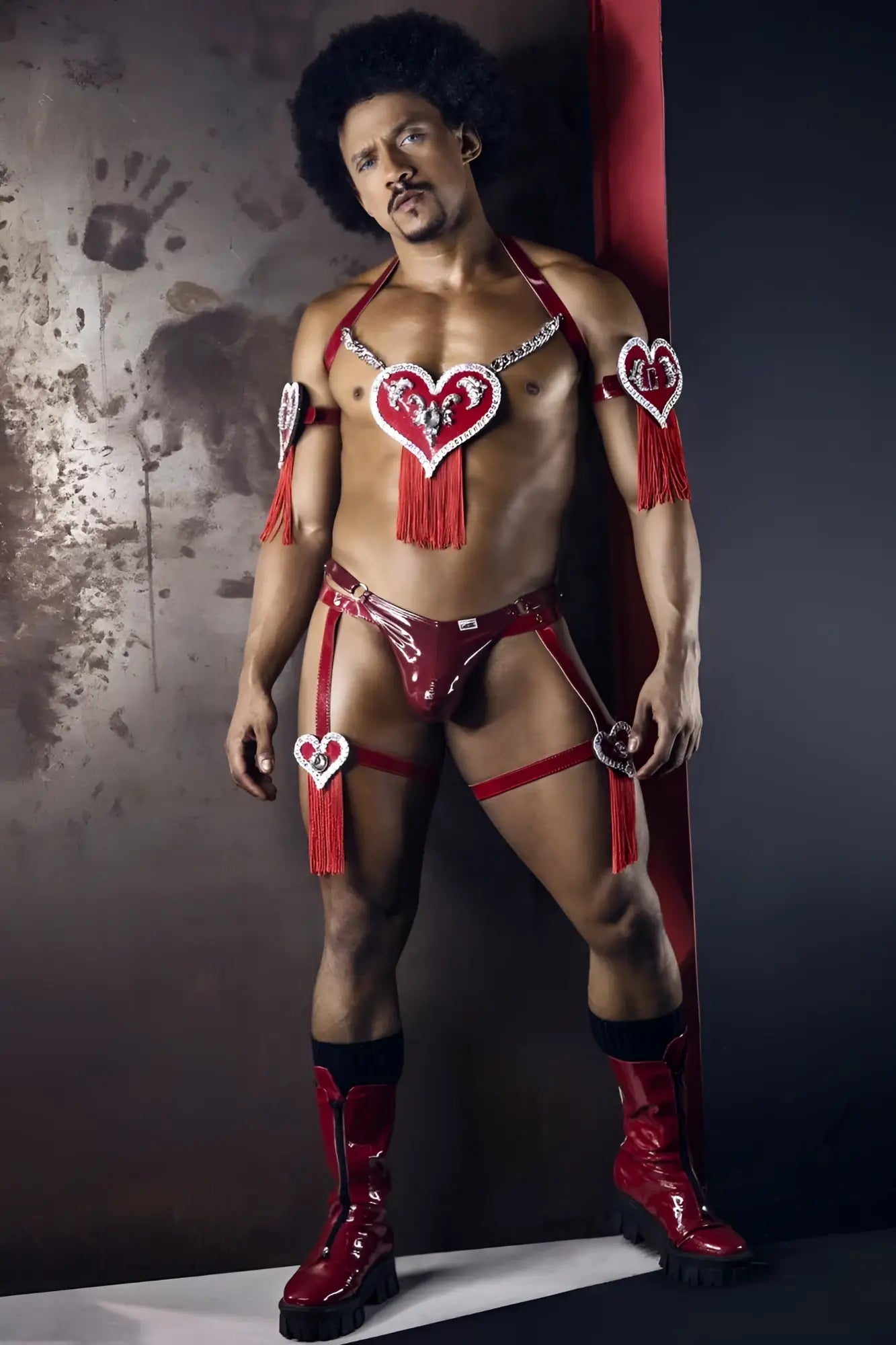 CandyMan 99819 dom thongs in gloss wine red latex with heart-shaped embellishments and tassels visible from the back