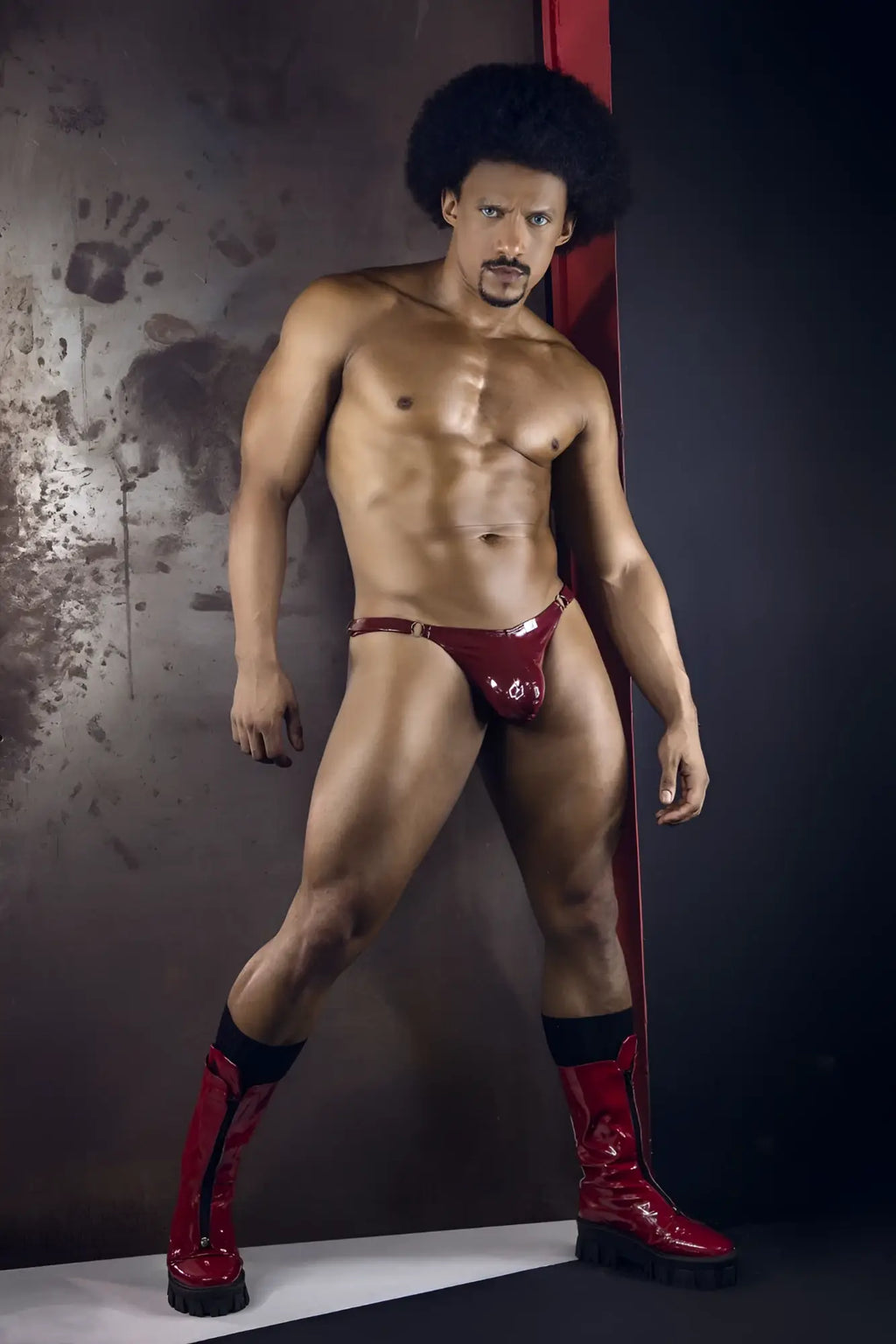 Shiny red latex dom thong with metallic buckle candyMan 99819 color gloss wine shown from the back side