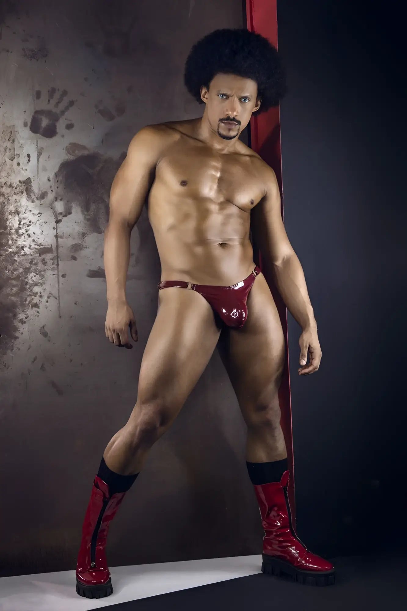 Shiny red latex dom thong with metallic buckle candyMan 99819 color gloss wine shown from the back side