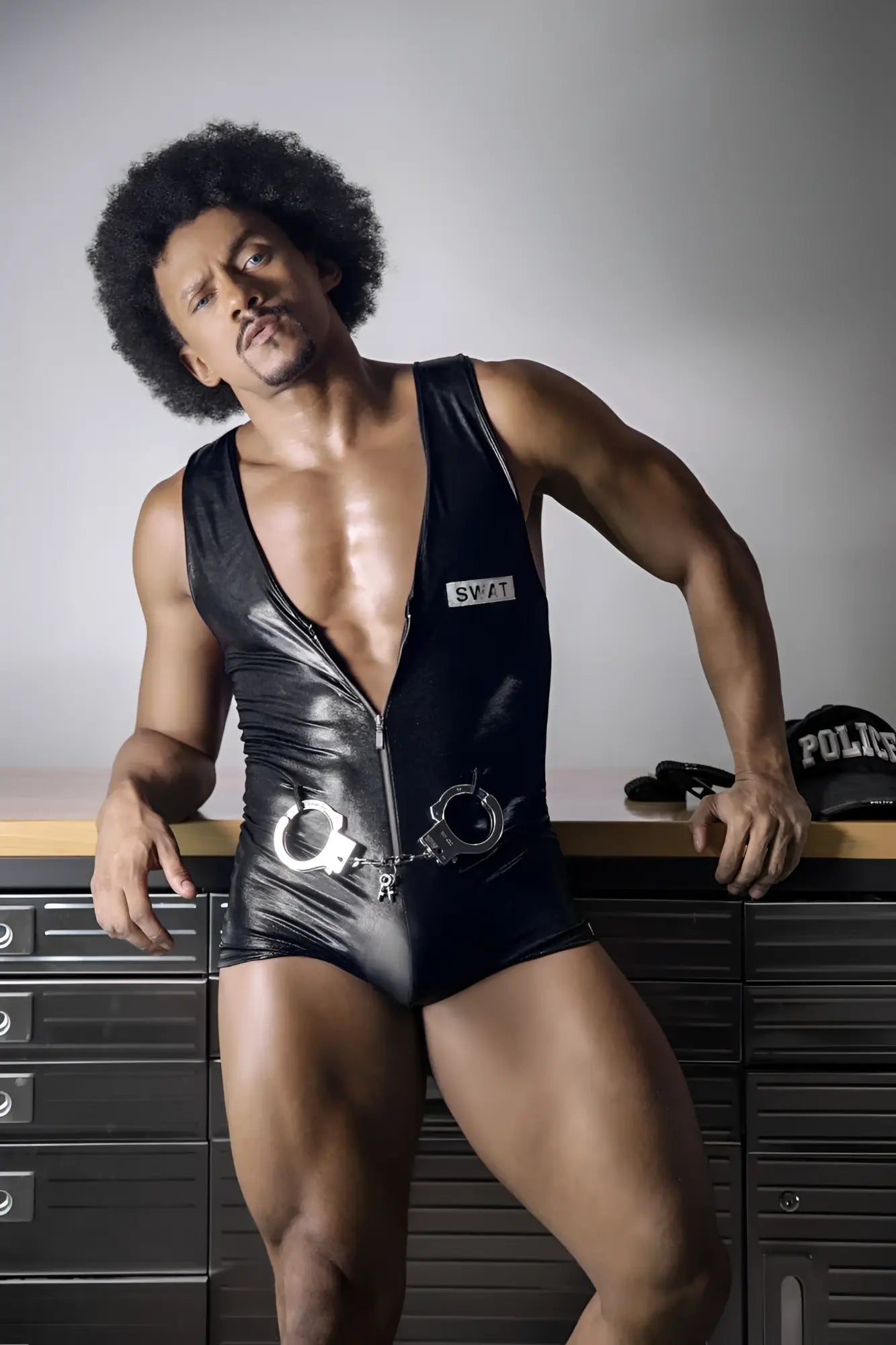 Black shiny vinyl CandyMan 99844 police bodysuit with silver handcuffs attached at the waist