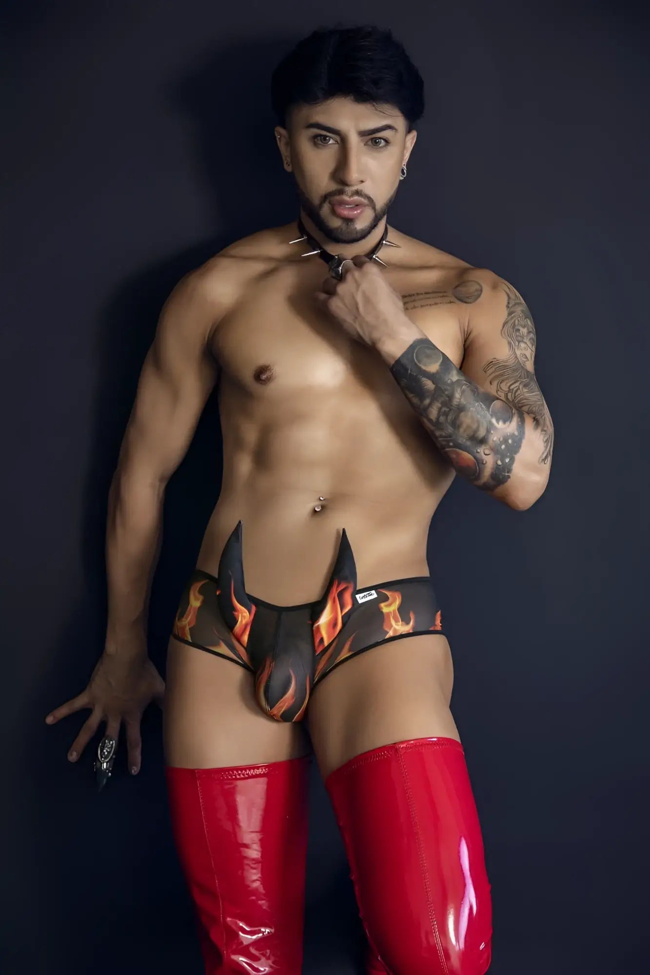 CandyMan 99917 wicked trunks black black and orange flame-patterned briefs with glossy red latex thigh-high boot