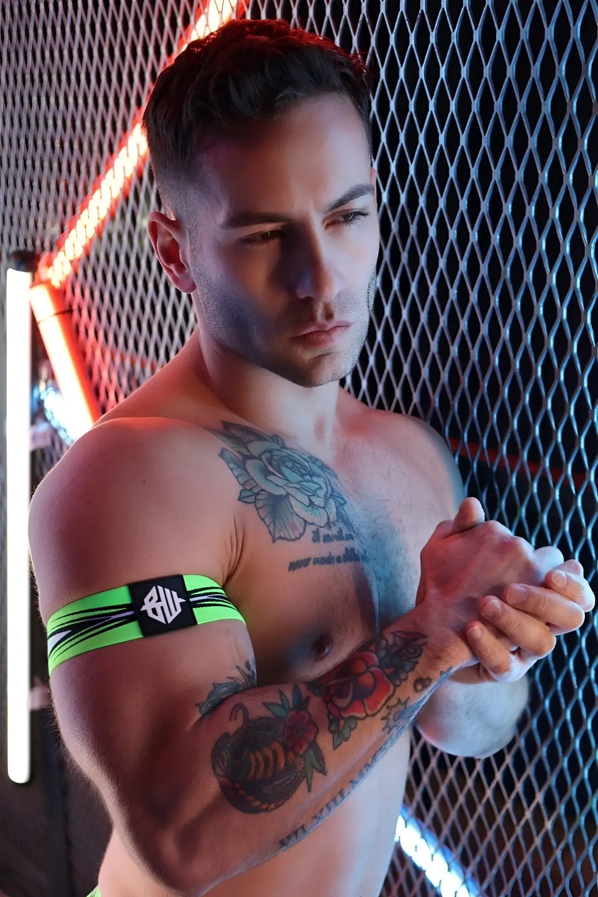 Neon green and black striped circuit breaker armband with central logo patch made of durable fabric for sports use