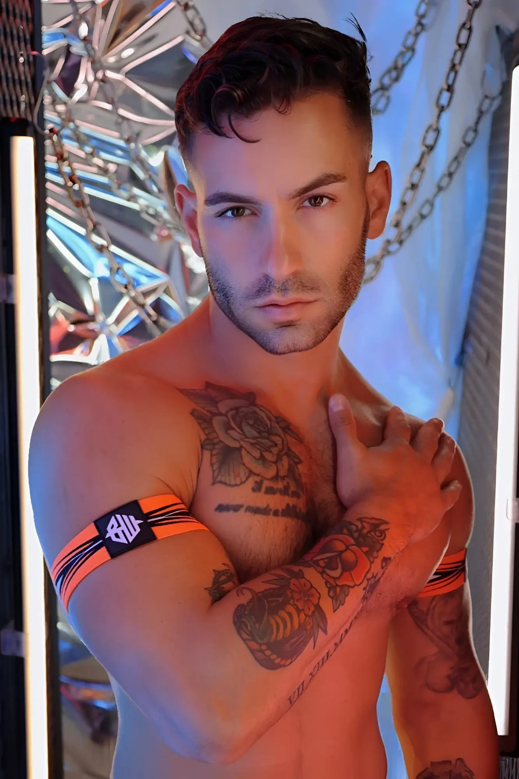 Orange and black striped circuit breaker armband with black rectangular logo patch made of durable fabric
