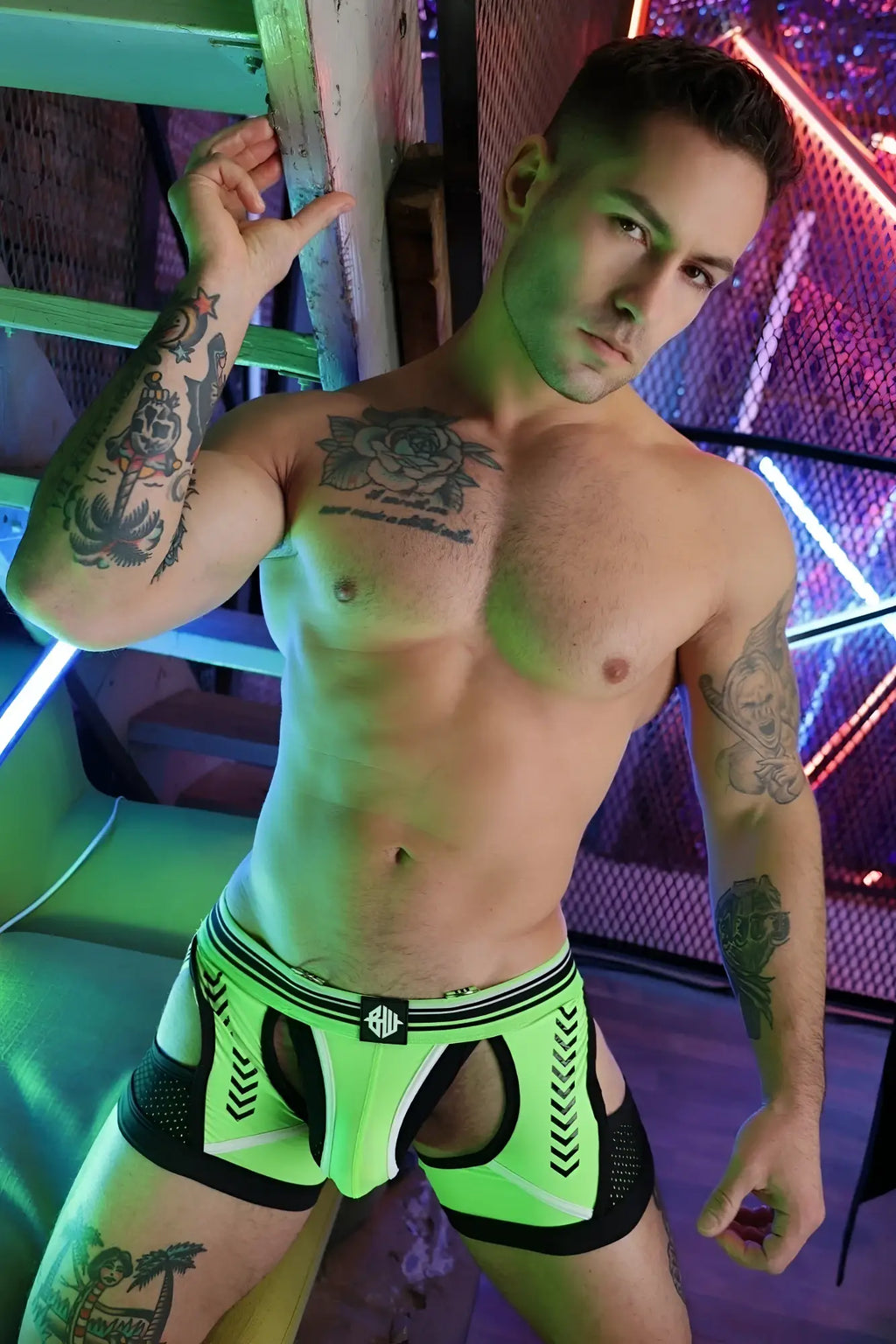 Neon green and black athletic briefs circuit breaker chock with bold geometric design for active wear